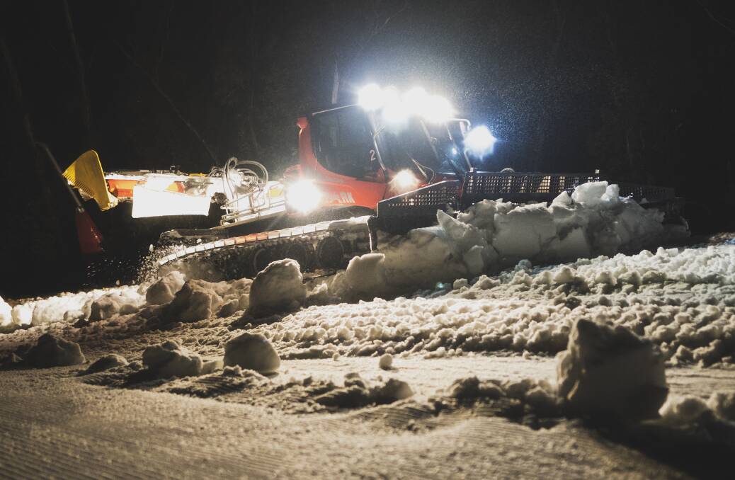 Working through the dead of night, Jeremy Blake's team of snow cat operator push, pull and preen the snow in readiness for the next day. Picture: Dion Georgopoulos