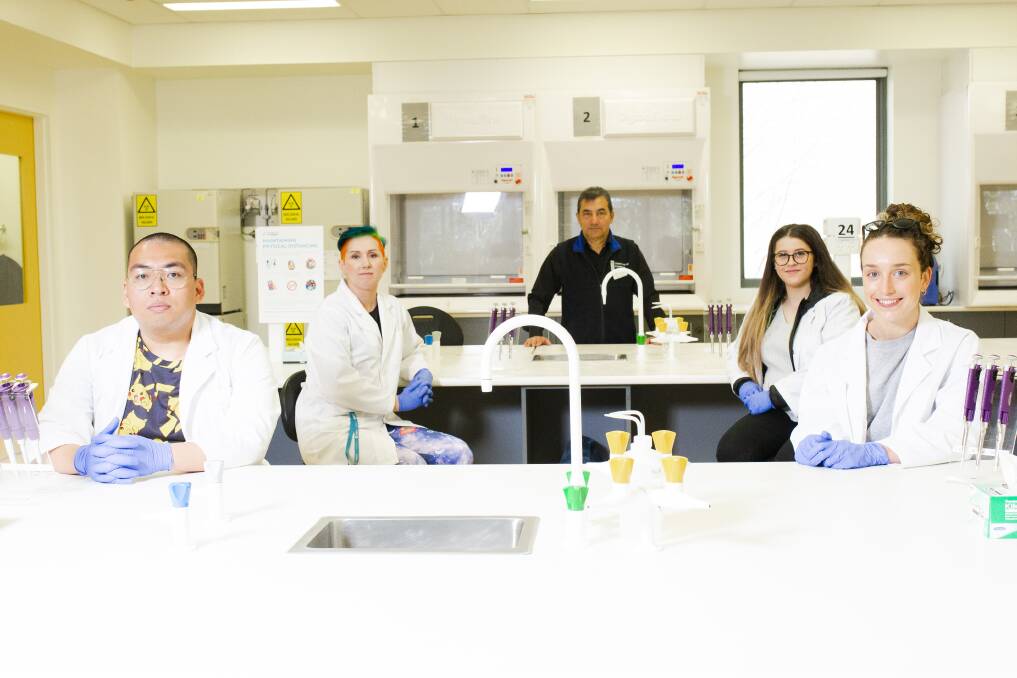University of Canberra will give courses that require laboratories priority for in-person learning. Students Alistair Gammad, Emily Ryan, technical officer Michaela Popham, senior science officer Ruben Ramirez, and student Alanah Pike practice their physical distancing at a University of Canberra laboratory. Picture: Jamila Toderas