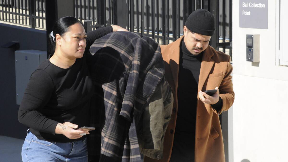 Ropati Dominic Finau hides under a jacket as he is escorted from the ACT court cells on Wednesday morning. Picture: Cassandra Morgan