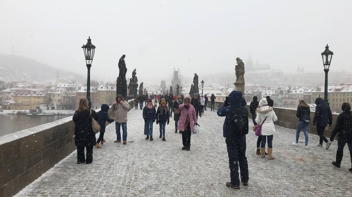 Tourists in winter on the Charles Bridge in Prague. 