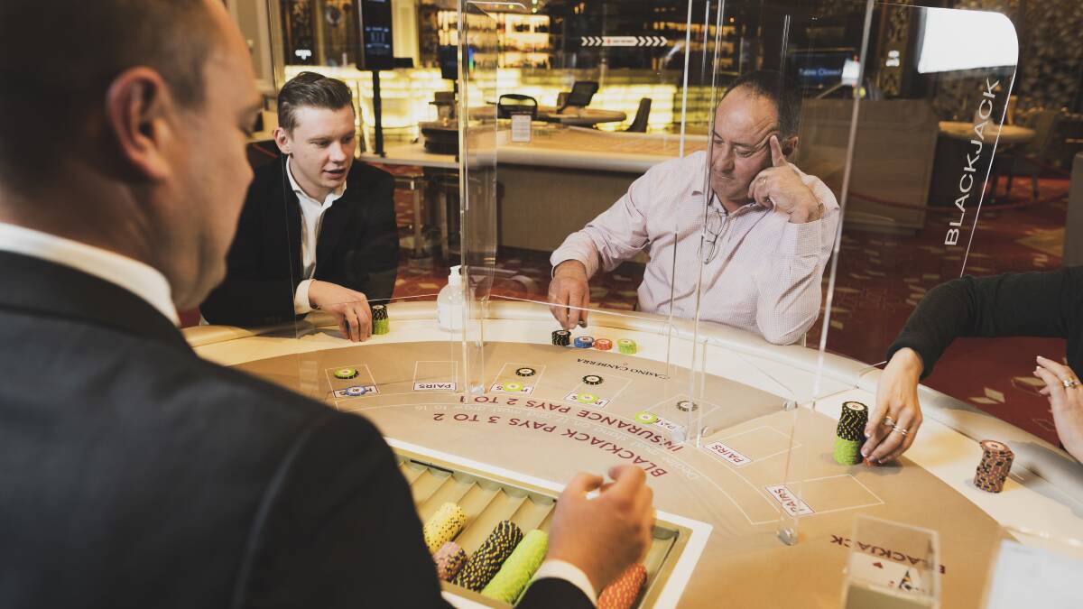 Patrons play blackjack at Casino Canberra which boasts new COVID-19 measures to ensure social distancing between players. Picture: Dion Georgopoulos