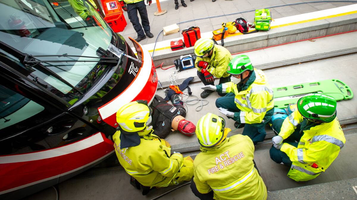 Emergency crews carry out a simulation of a crash between a light rail vehicle and a pedestrian in Gungahlin. Pictures: Karleen Minney