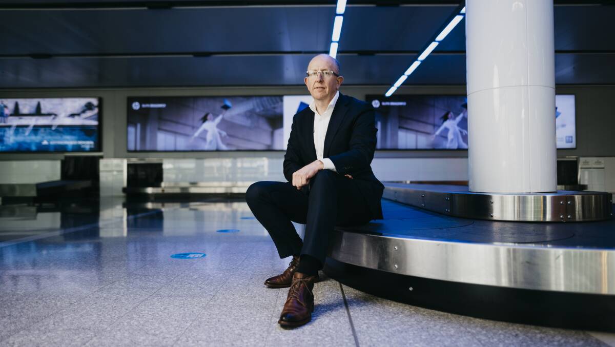 Managing director Stephen Byron sits at an empty baggage reclaim area as Canberra Airport nears its closure. Picture: Dion Georgopoulos