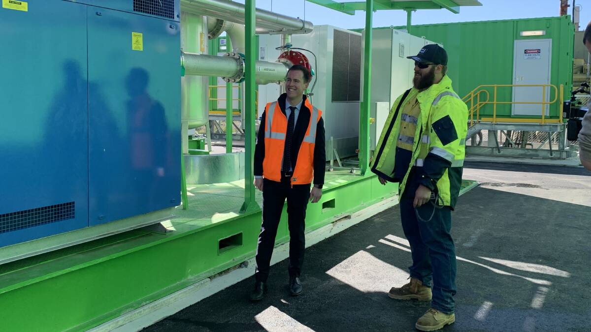 ACT Waste Reduction Minister Chris Steel (left) with Landfill Gas Industries employee Brandyn Threlfall at the new landfill gas generators in Mugga Lane. Picture: Andrew Brown