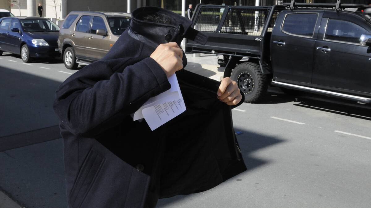 Kenny Choi tries to hide from the media outside court earlier this month. Picture: Blake Foden