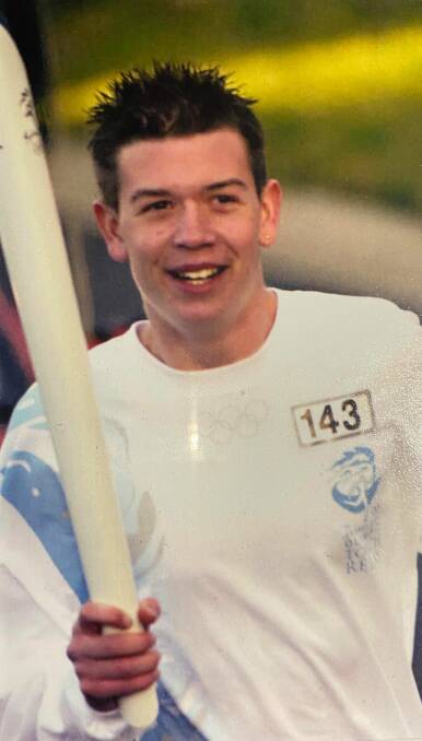 Paul Sait, then 13, carrying the Sydney 2000 Olympic torch through the streets of Farrer. Picture: Supplied