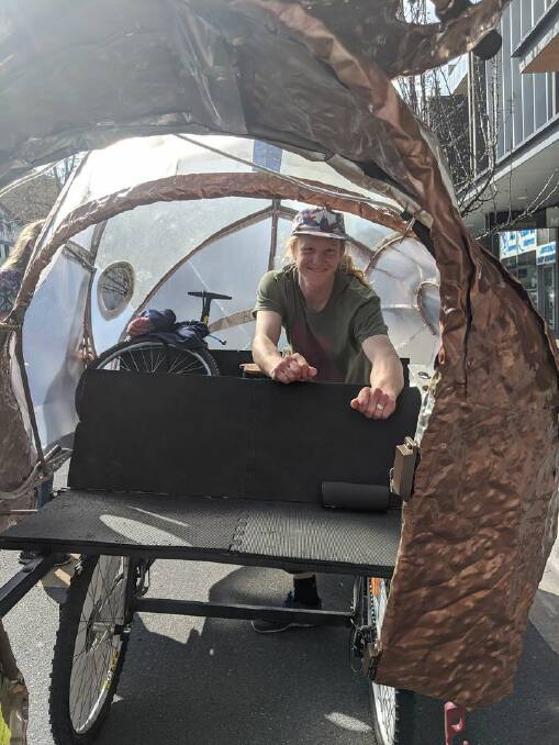 Travis Bullock operates Shelly the snail with bike pedals.
