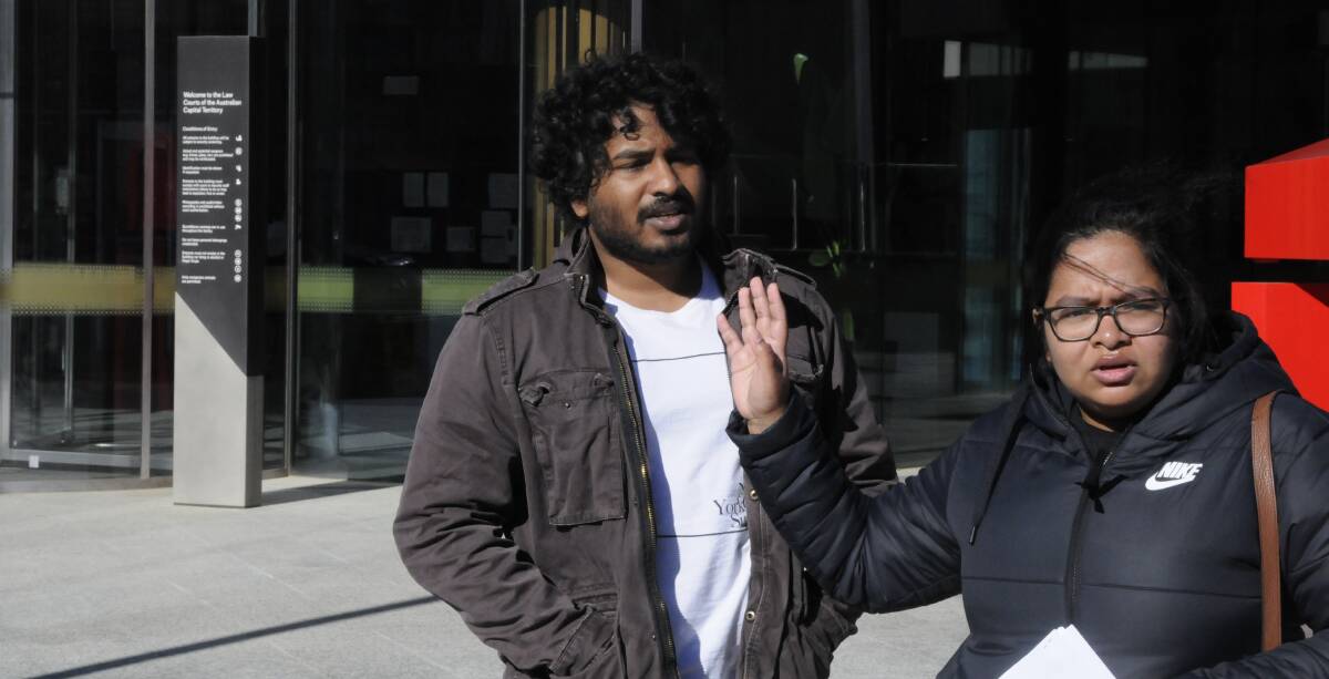 Chavin Seneviratne, left, outside court last month with an angry supporter who demanded that a journalist not take pictures. Picture: Blake Foden