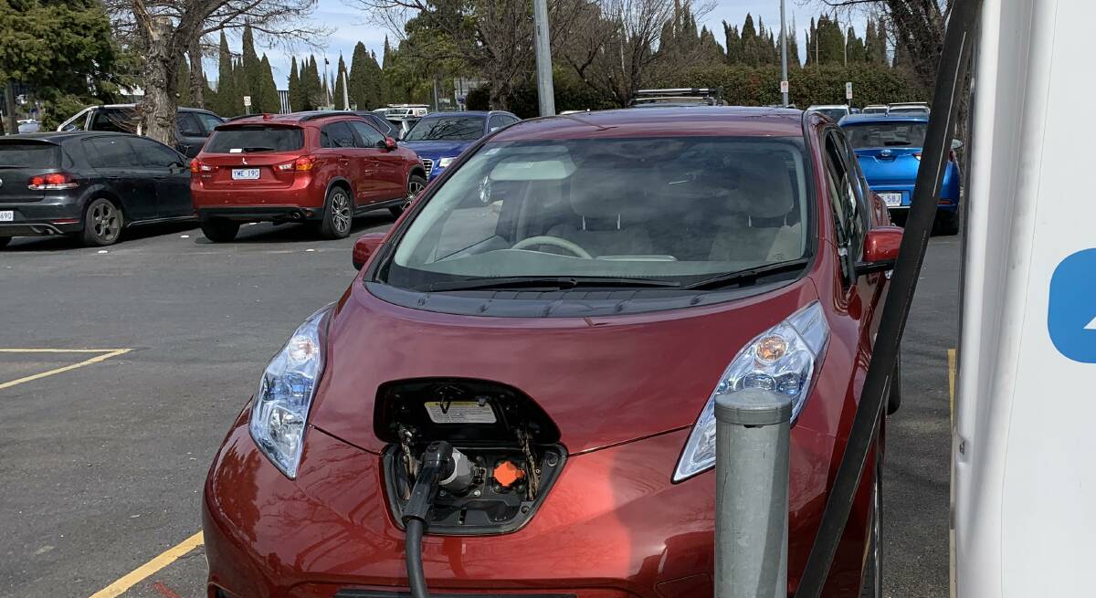An electric vehicle plugged into a recharging station in Civic. Picture: Peter Brewer