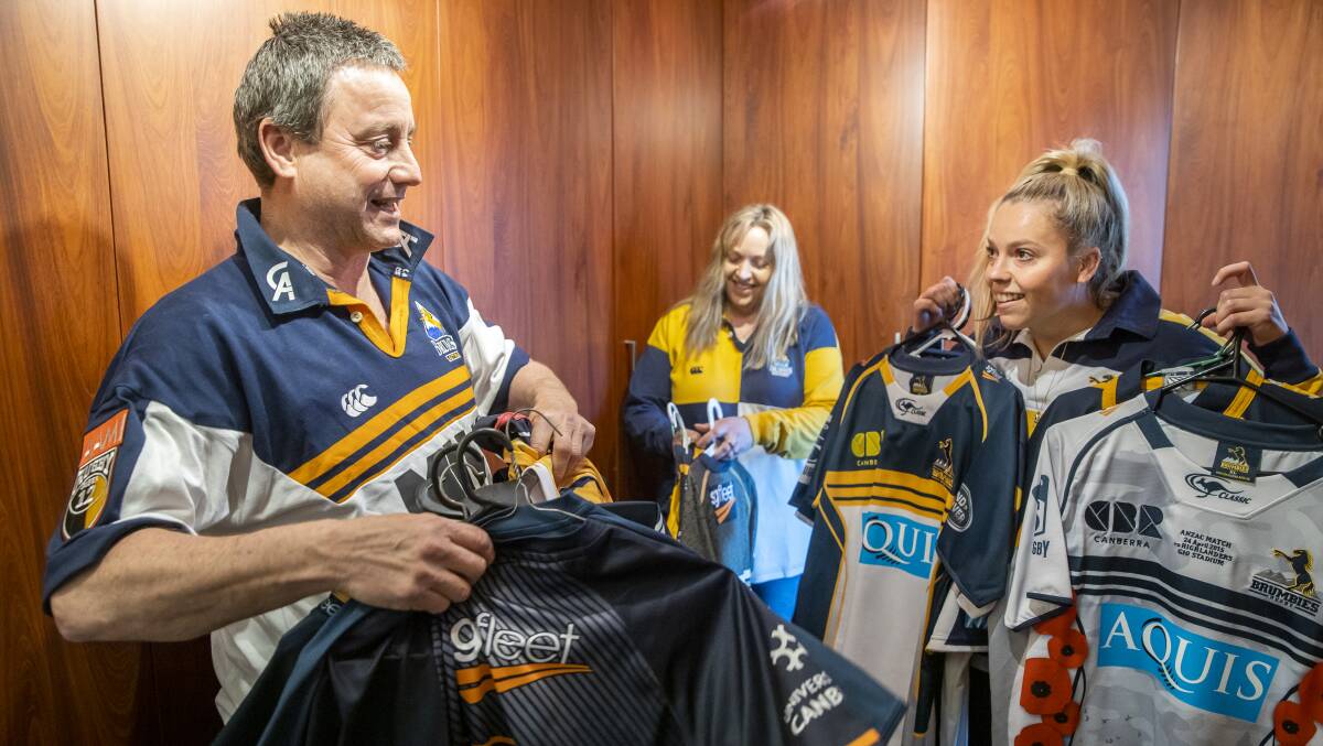 They've got tickets, now Jim Taylor needs to work out which jersey to wear alongside wife Jody and daughter Beth. Picture: Sitthixay Ditthavong
