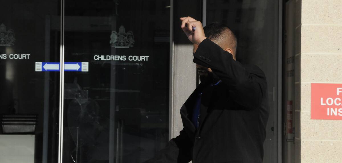 Kerrod Edwards shields his face as he leaves the ACT Supreme Court following day one of his trial. Picture: Blake Foden