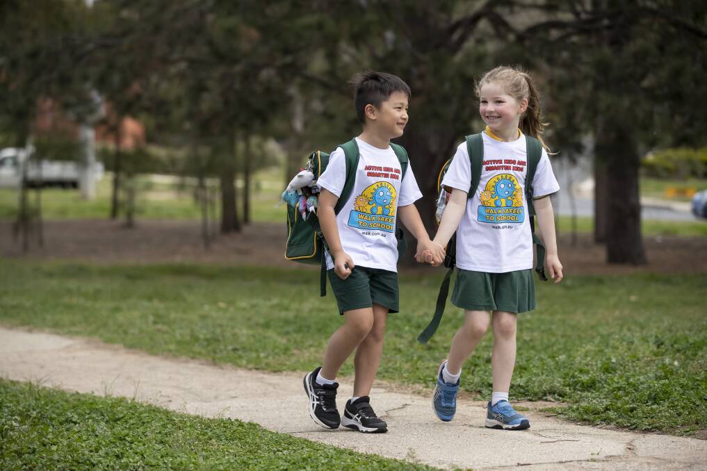 Red Hill Primary School Year 1 students Rayan Keat and Sophia Forjanic get ready for National Walk Safely to School Day. Picture: Sitthixay Ditthavong
