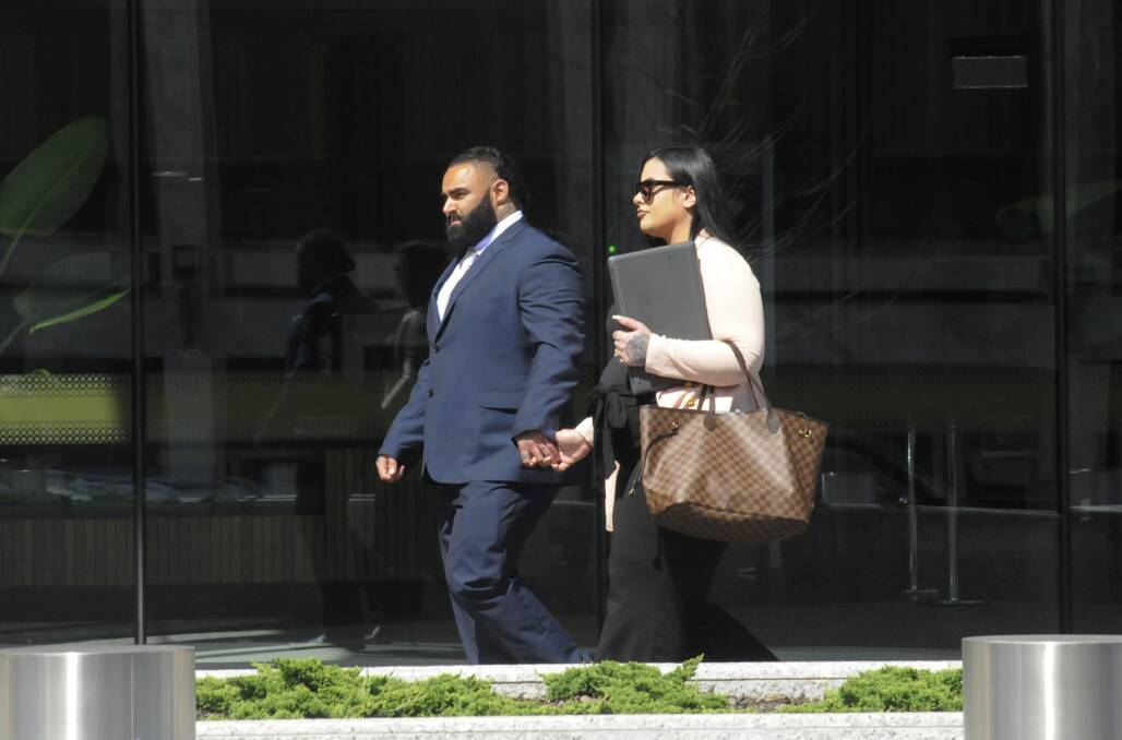 Benjamin James Moarefi (left) outside the ACT courts with his wife, Anna Roufogalis. The expectant father is accused of aiding and abbetting alleged gunman, Christopher Cunningham. Picture: Cassandra Morgan