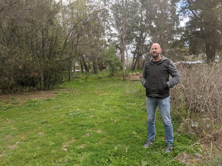 Yarralumla Play station director Jason Perkins on the site of the old Weston Park maze, with blackberries overgrowing it