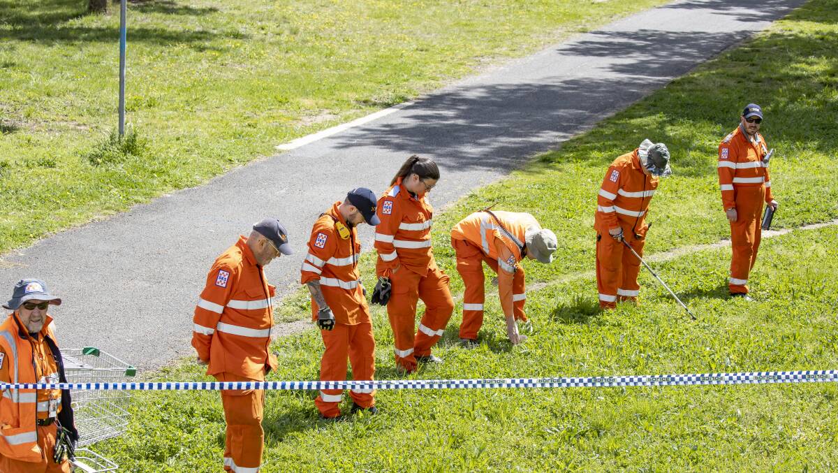SES volunteers comb the area around Dillon Close for evidence after a young man was fatally stabbed at Weston skatepark. Picture: Sitthixay Ditthavong 