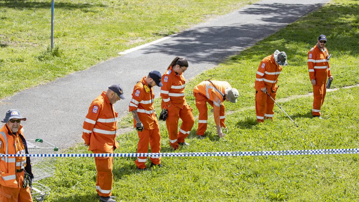SES volunteers comb the area around Dillon Close, Weston for evidence after a young man was fatally stabbed near the skatepark in the early hours of Sunday morning. Picture: Sitthixay Ditthavong