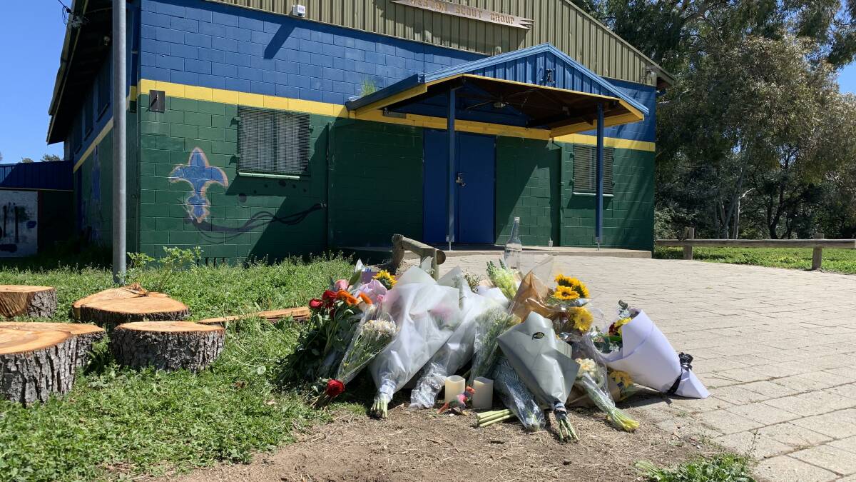 Outside the Weston Scout Hall, bunches of flowers have been left at the scene of the fatal Sunday morning stabbing. Picture: Peter Brewer