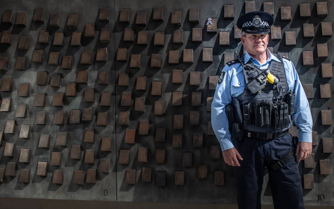 Former Vicpol officer, ACT Detective Inspector Marcus Boorman pays his respects at the police memorial for friend Leading Senior Constable Lynette Taylor, one of four officers killed on duty on a Victorian freeway on April 22 this year. Picture: Karleen Minney
