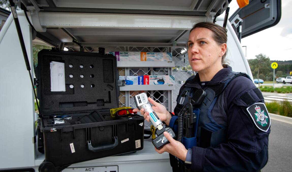 Police senior constable and forensic crime scene investigator Jessica Brenner with an ultra-violet light used to detect blood, fibres and other material. Picture: Elesa Kurtz 