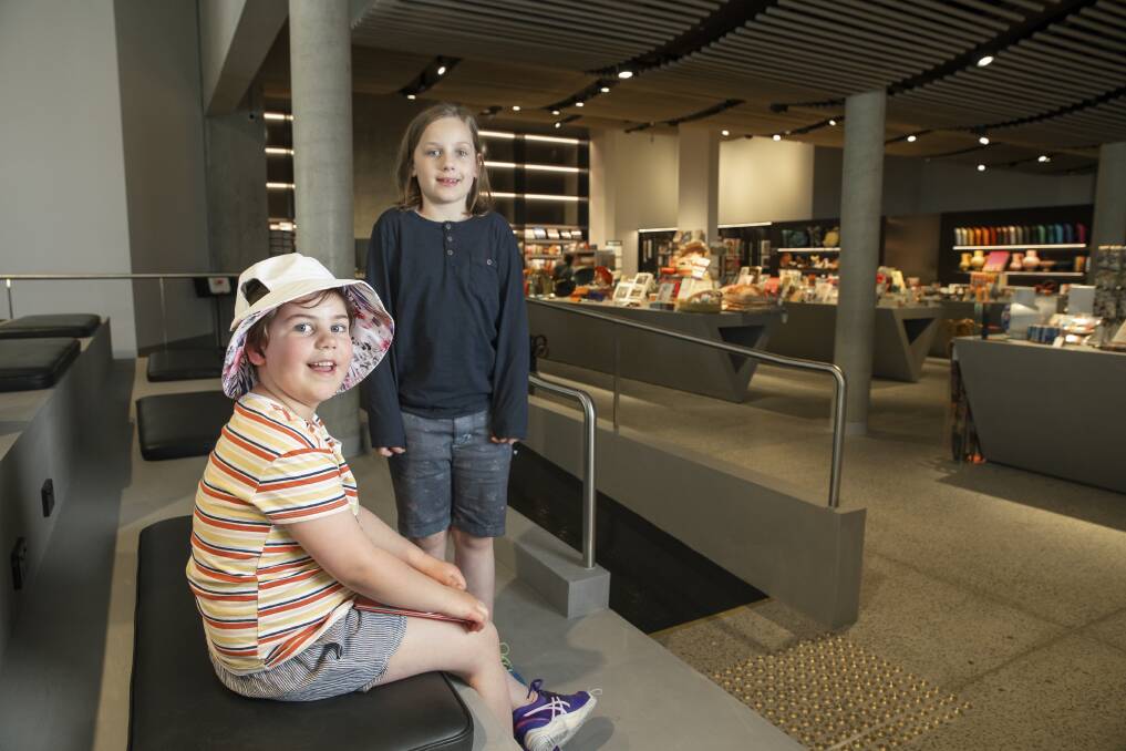 Watson sisters Maisy, six, and Matilda, eight, Kirchner-Clarke in the new seating area at the National Gallery of Australia's Art Store. Picture: Sitthixay Ditthavong