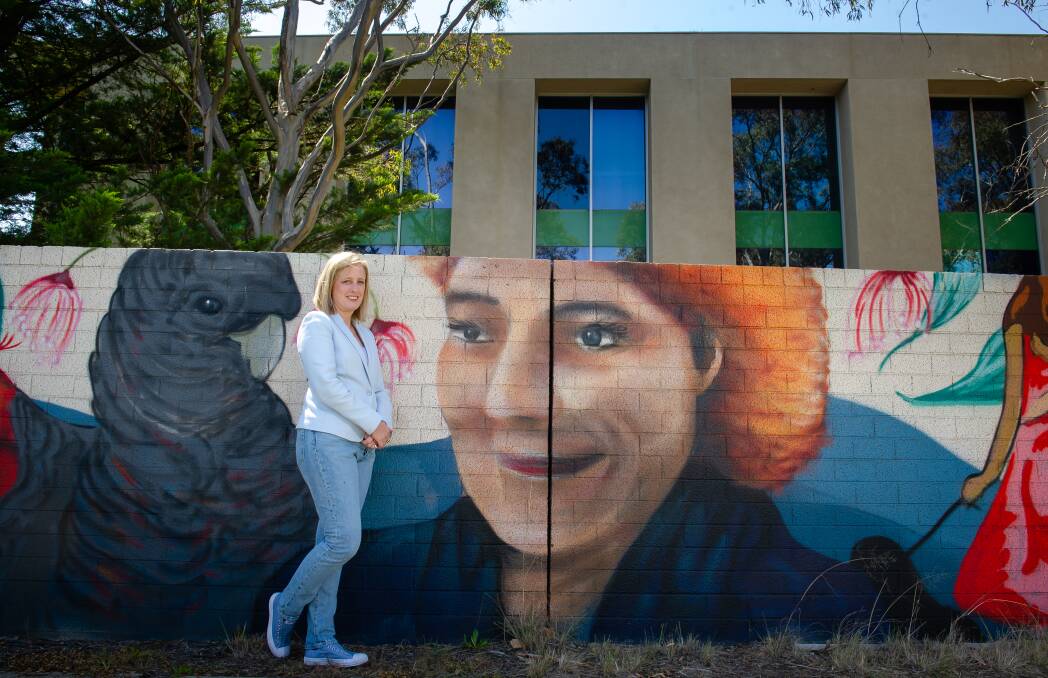 Senator Katy Gallagher on Friday with the mural of mum Betsy behind Corinna Chambers where her new office will be located. Picture: Elesa Kurtz 