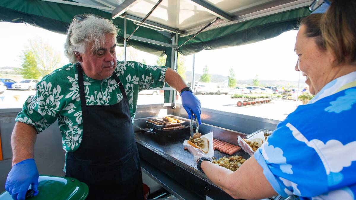 John Sanderson and Caryn Scott on the grill as sausage sizzles return to Bunnings. Picture: Elesa Kurtz - THE CANBERRA TIMES, ACM