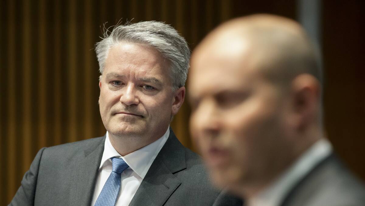 Finance Minister Mathias Cormann listens to Treasurer Josh Frydenberg answer questions on the Federal Budget during a media briefing on Tuesday. Picture: Sitthixay Ditthavong