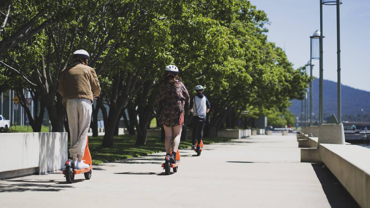 People riding Neuron e-scooters at Queen Elizabeth Terrace in Canberra. Picture: Dion Georgopoulos 