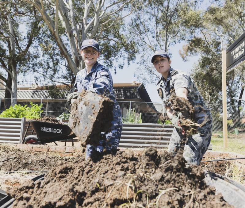 Officer cadet Lily Attwood (left) and navy midshipman Emily Kolokotas working at Canberra College. Picture: Dion Georgopoulos