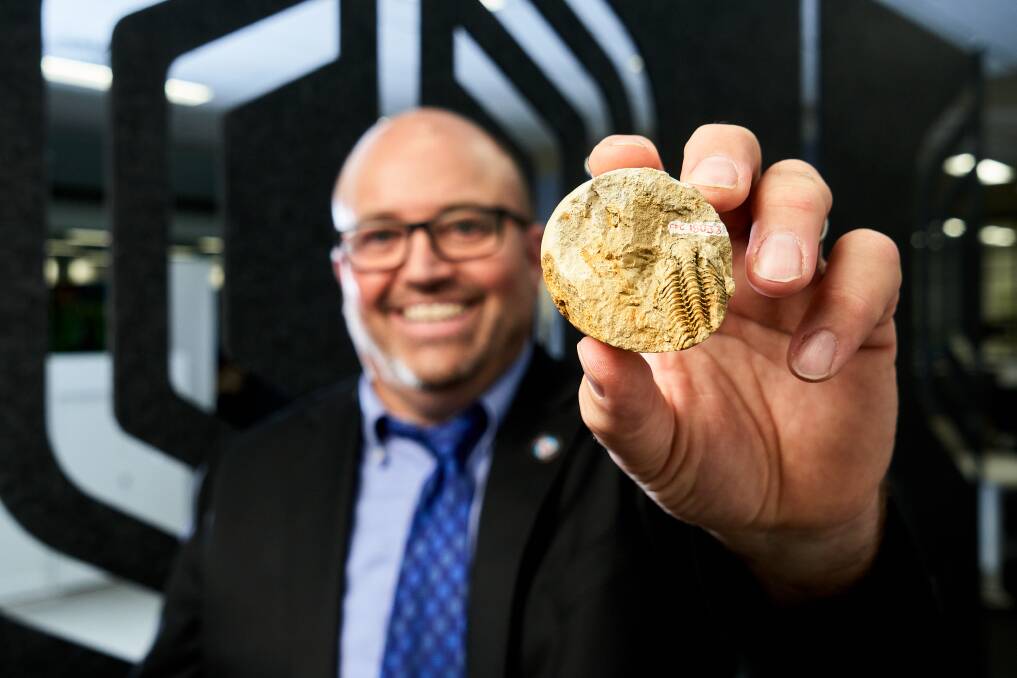 Geoscience chief scientist Dr Steve Hill with the new ACT Fossil Emblem, a Botocara mitchelli. Picture: Matt Loxton