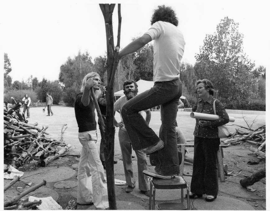 Bruce Reynolds (on chair) and Andrew Townsend, left, installing at Australia 75 in Commonwealth Park. Picture: ArchivesACT.
