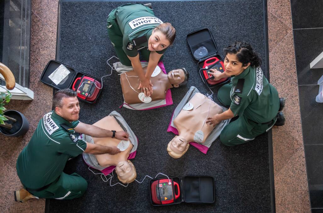 St John Ambulance responders Phil Thomas, Ana Benton and Sarah Ahmad demonstrate how to use a defibrillator. Picture: Karleen Minney