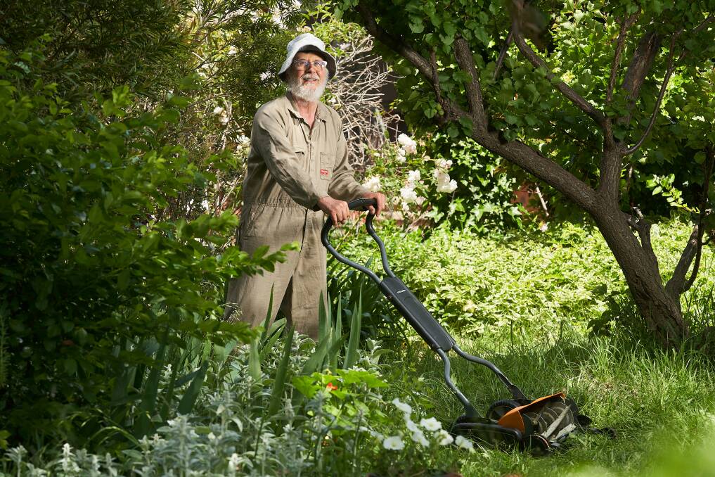 Jorge Gapella with his manual lawnmower at his home in Kaleen. Picture: Matt Loxton