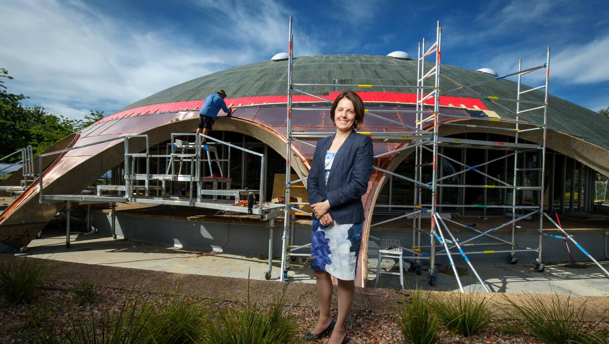 Australian Academy of Science chief executive Anna-Maria Arabia and the Dome as the new roof goes on. Picture: Sitthixay Ditthavong