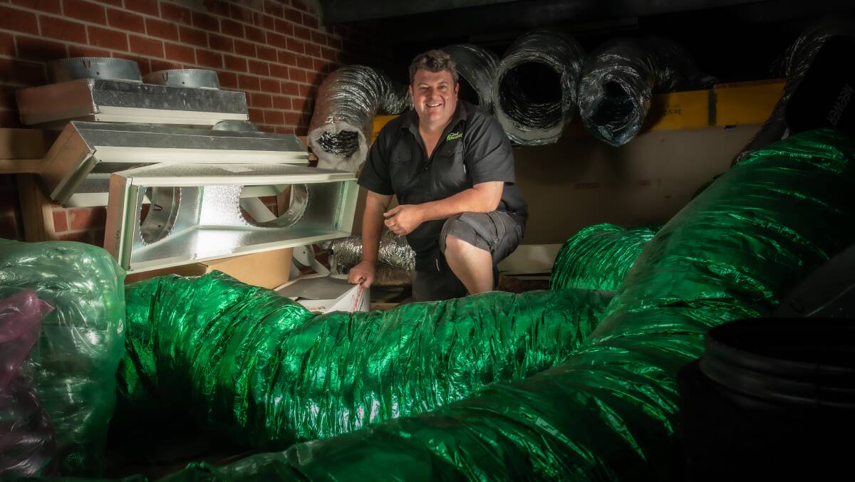 Aaron Clark of Clark Electrical, with ducts at his Mitchell warehouse, says the air conditioning trade is very busy in the lead up to Christmas. Picture: Karleen Minney