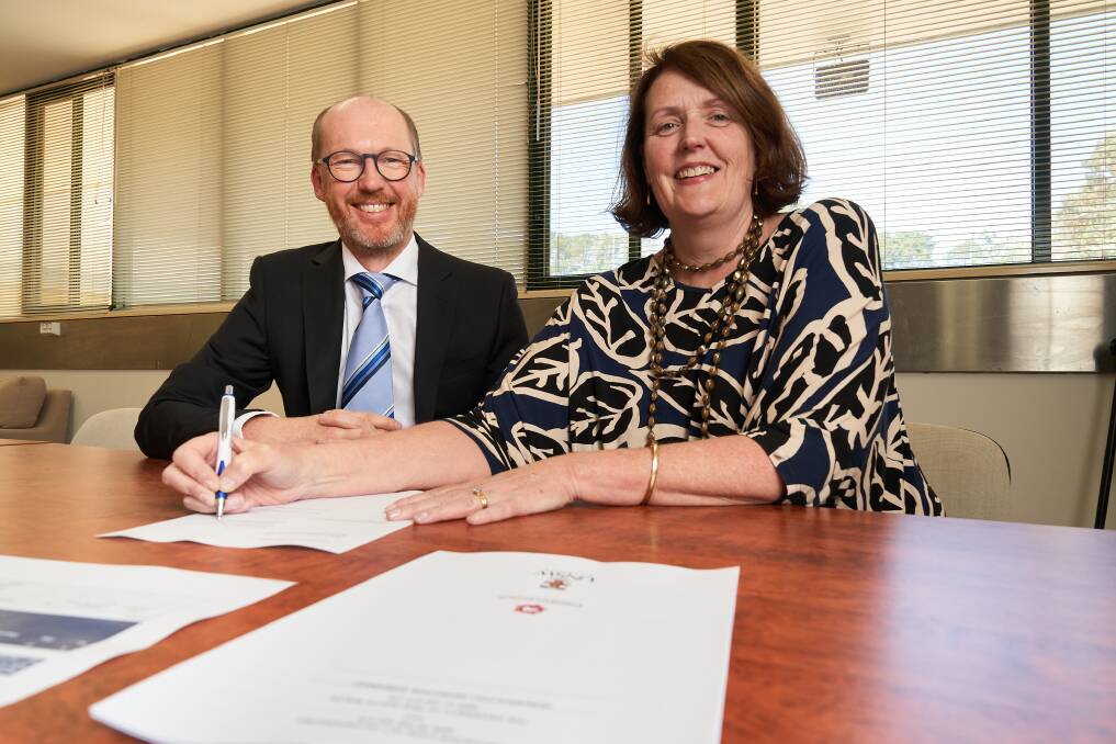 Dr James Connor from UNSW Canberra and Palliative Care ACT president Louise Mayo said the three-year research agreement on palliative care to improve outcomes for carers and their families. Picture: Matt Loxton