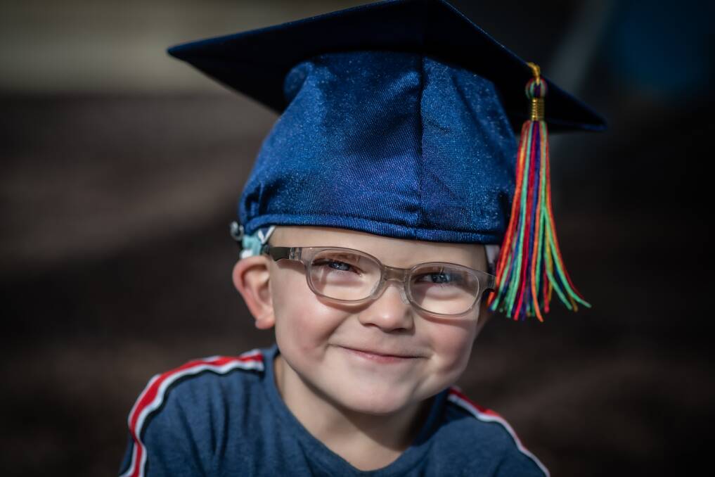 Harry Rupil, 5, will don his graduation cap for an online ceremony on Thursday to celebrate his completion of The Shepherd Centre therapy program. Picture: Karleen Minney