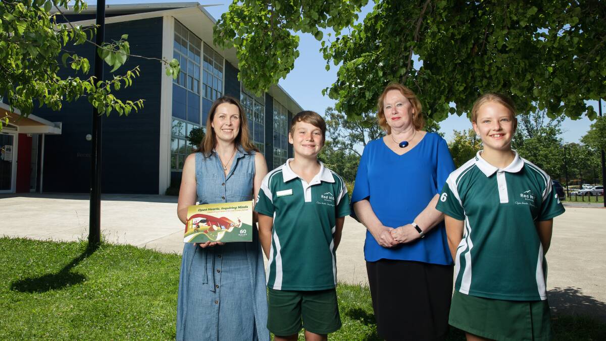 Historian Emma Campbell with Red Hill Primary School captains Bailey Anderson and Maddie Harris-Talbot and principal Louise Owens. Picture: Sitthixay Ditthavong