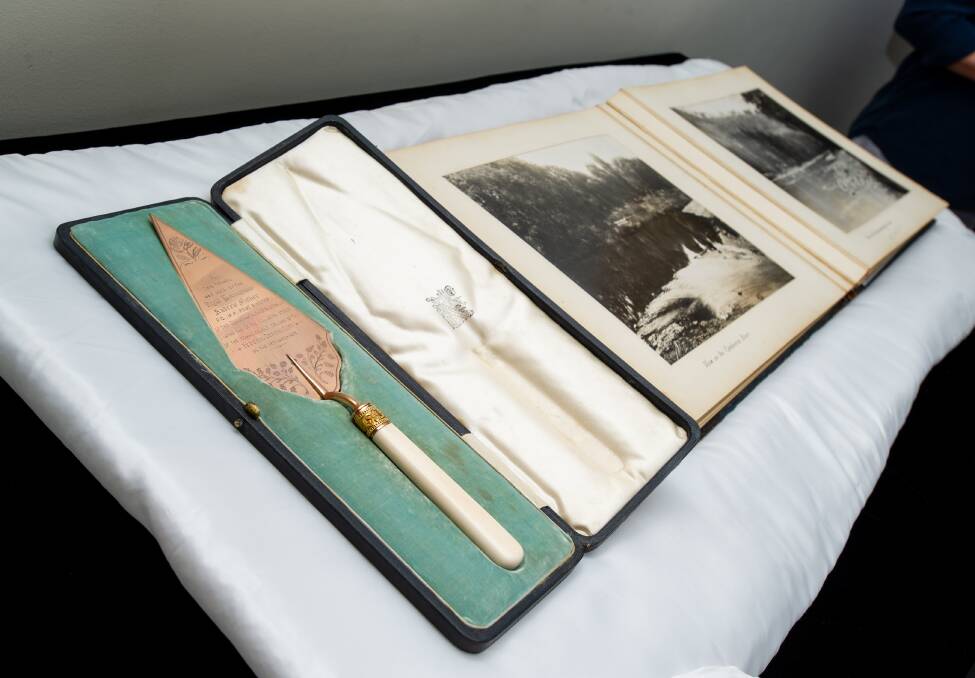 The golden trowel used by prime minister Andrew Fisher to lay a foundation stone on March 12, 1913, alongside the Mildenhall album at the National Museum of Australia. Picture: Elesa Kurtz