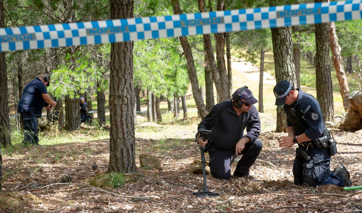 Police use metal detectors to search the Fairbairn pine plantation in the 49-year-old murder case of Canberra woman Keren Rowland. Picture: Elesa Kurtz