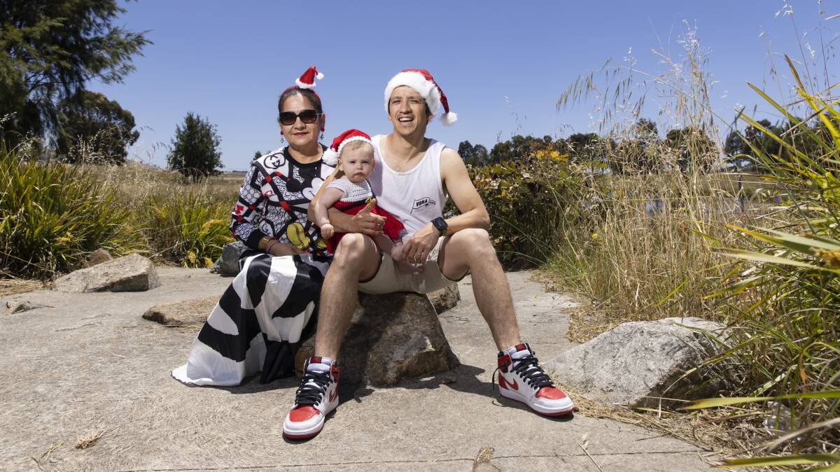 Cesar Corripio, his mum Esther Rosado and baby Ailana Corripio, 7 months, are ready to welcome the warmer weather as the ACT heads into Christmas. Picture by Keegan Carroll