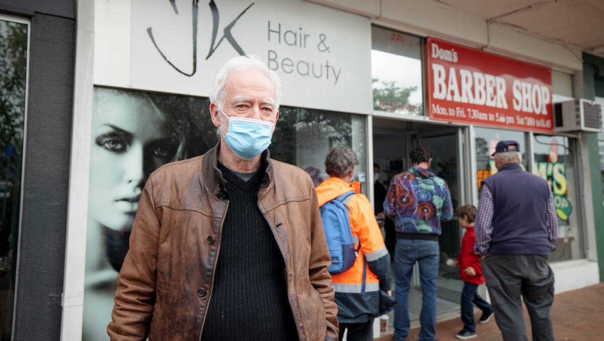 Paul Hartigan joined others in the queue for Dom's Barber Shop in Dickson on Friday morning. Picture: Sitthixay Ditthavong