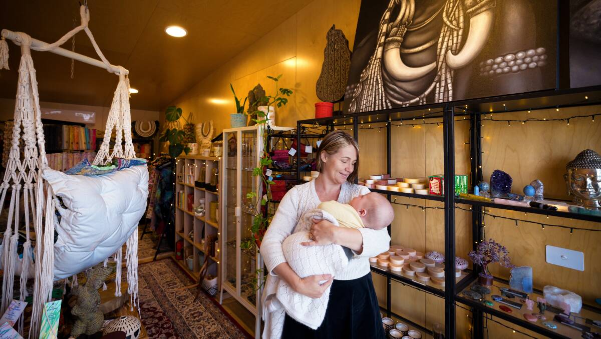 Laura Haynes, pictured with son Remi Toal, is rebuilding her boutique shop Life's Little Pleasures in the Cobargo Business Innovation Hub after losing everything in the 2020 bushfire. Picture by Sitthixay Ditthavong