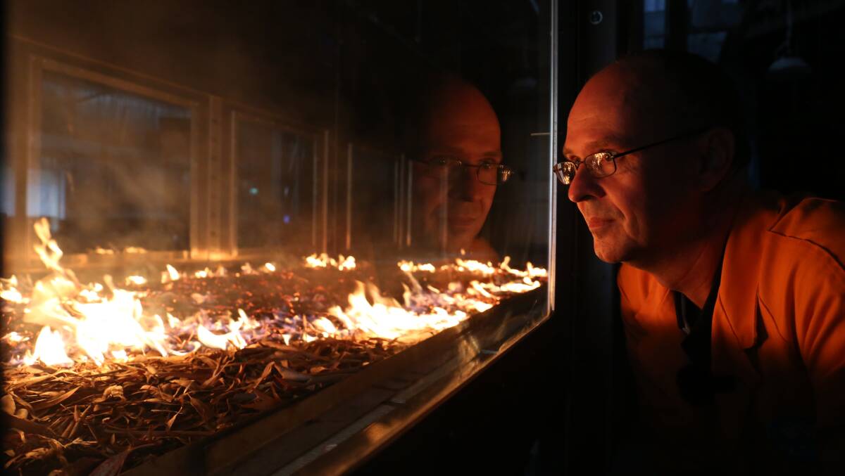 CSIRO fire expert Dr Andrew Sullivan observes a simulation in the Pyrotron, a combustion wind tunnel for researching bushfire behaviour. Picture: James Croucher