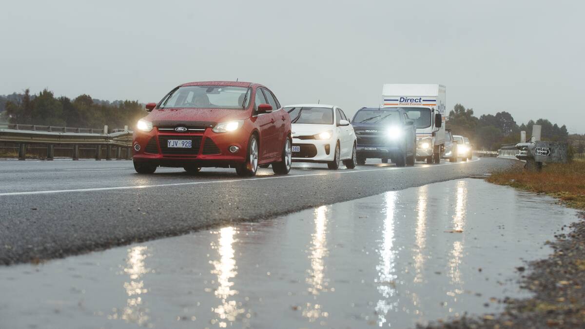 Peak-hour traffic on the Monaro Highway as heavy rainfall hits Canberra on Tuesday. Picture: Dion Georgopoulos