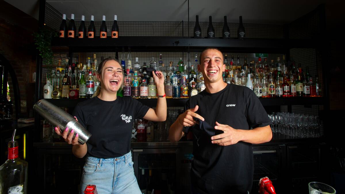 Assembly Bar staff Annelise Rajic and Sam Woolbank celebrate a relaxation of restrictions which will allow the Lonsdale Street bar to increase capacity from midnight on Thursday. Picture: Elesa Kurtz 