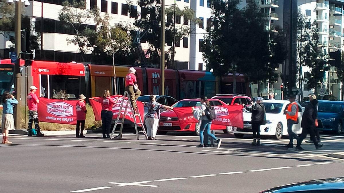 Climate activists have blocked traffic on Northbourne Avenue during the morning commute. Picture supplied