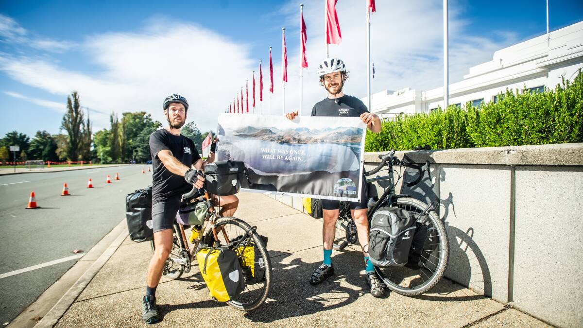 Andy Szollosi and Patrick Kirkby have ridden their bikes from Hobart to Canberra as part of a push to restore Lake Pedder. Picture: Karleen Minney