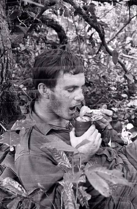 John Fairley on operations eating peaches from his ration pack. Picture: Supplied
