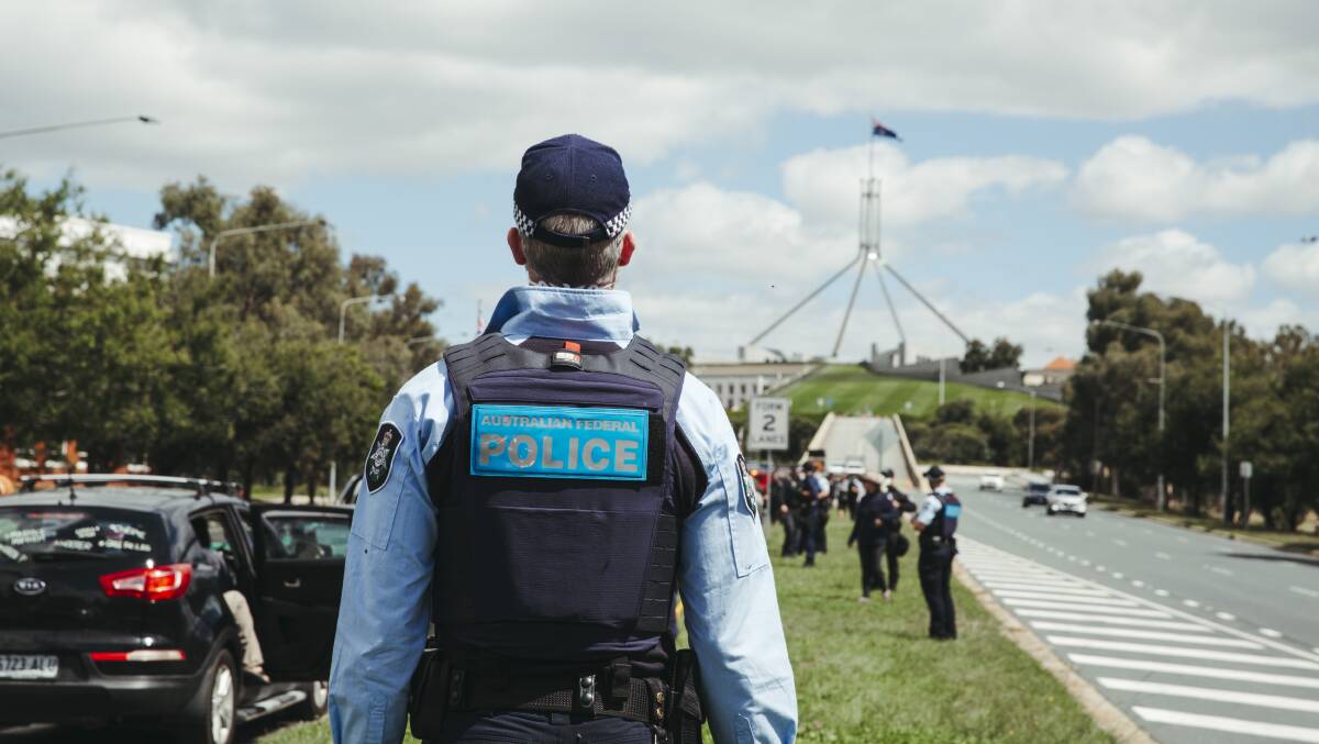 Police move on protestors who lined up vehicles at a road closure on the Commonwealth Avenue ramp towards Parliament House on the weekend. Picture: Dion Georgopoulos 